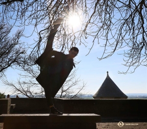 Dancer Scott Xu kicks toward the sun. (Photo by Nick Zhao)